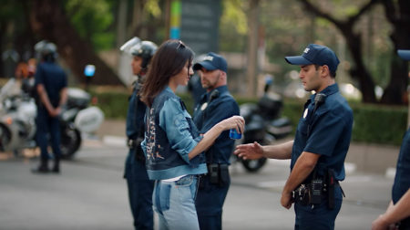Pepsi ad featuring Kendall Jenner offering a can of Pepsi to a police officer during protest